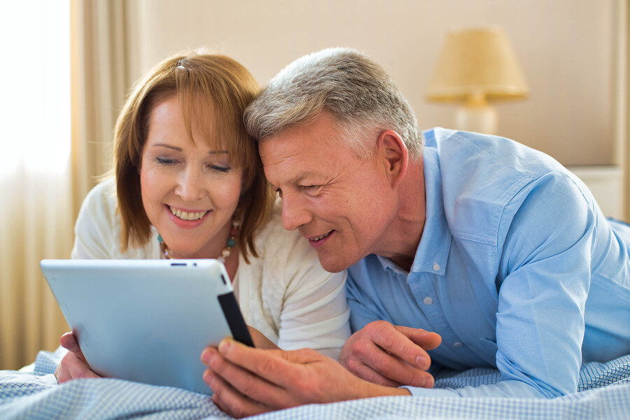 Germany, Berlin, Mature Couple Using Digital Tablet, Smiling